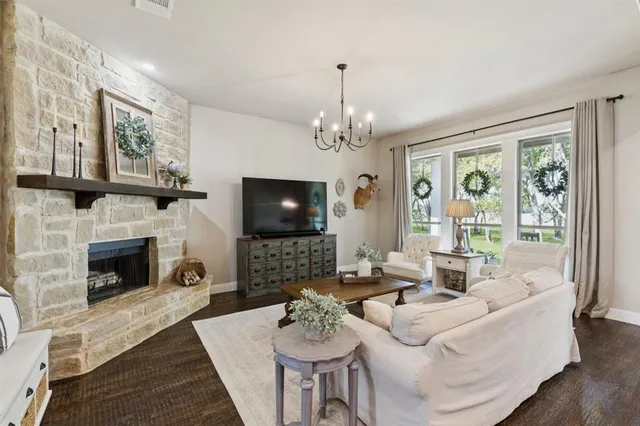 a living room with furniture a flat screen tv and a fireplace