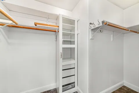 a view of walk in closet with empty racks