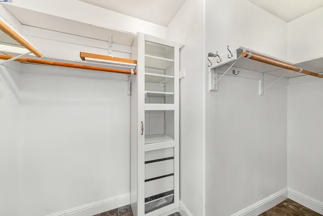 a view of walk in closet with empty racks
