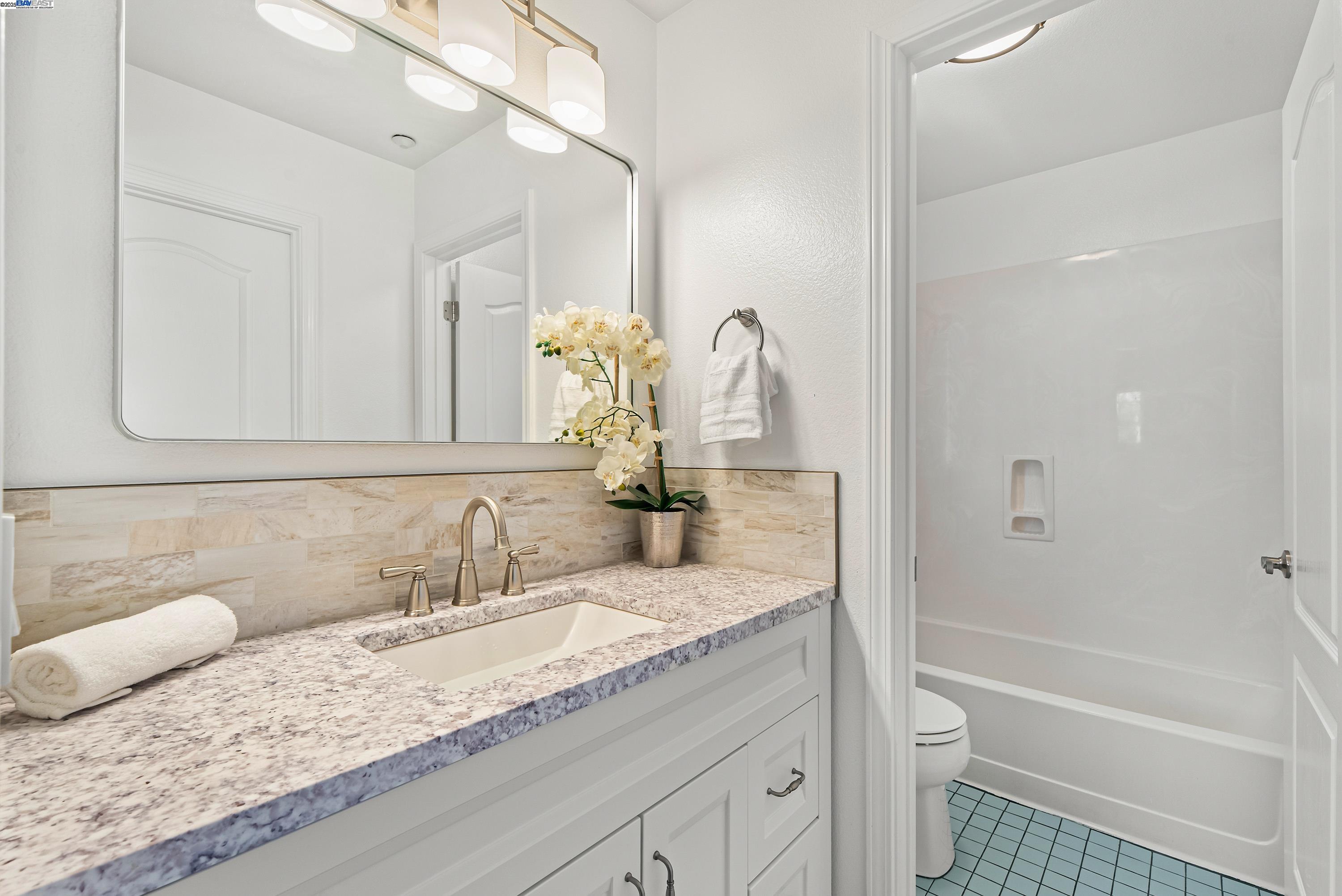 43 Ferdinand Way Novato, CA 94949 - Photo 30 of 43 a bathroom with a granite countertop sink a toilet and bathtub