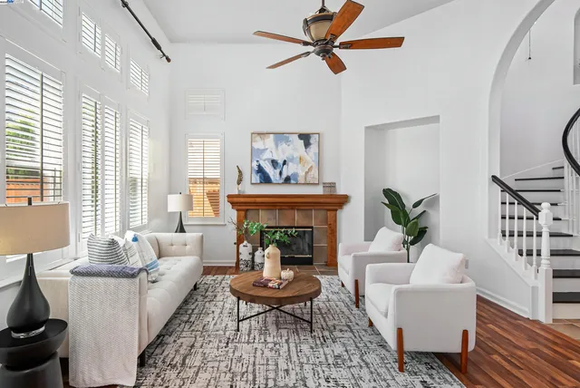 a living room with furniture a window and a fireplace