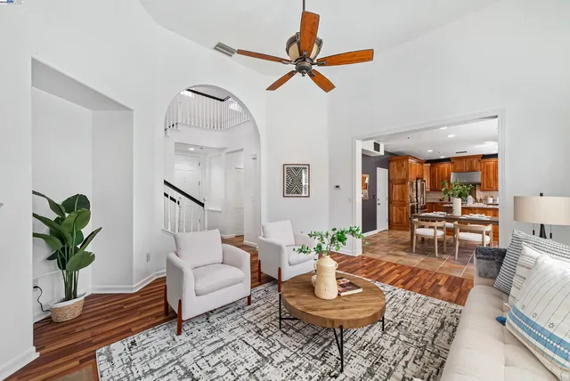 a living room with furniture and a potted plant