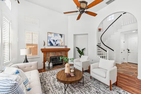 a living room with furniture a fireplace and a table
