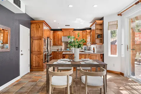a dining room with furniture and a floor to ceiling window