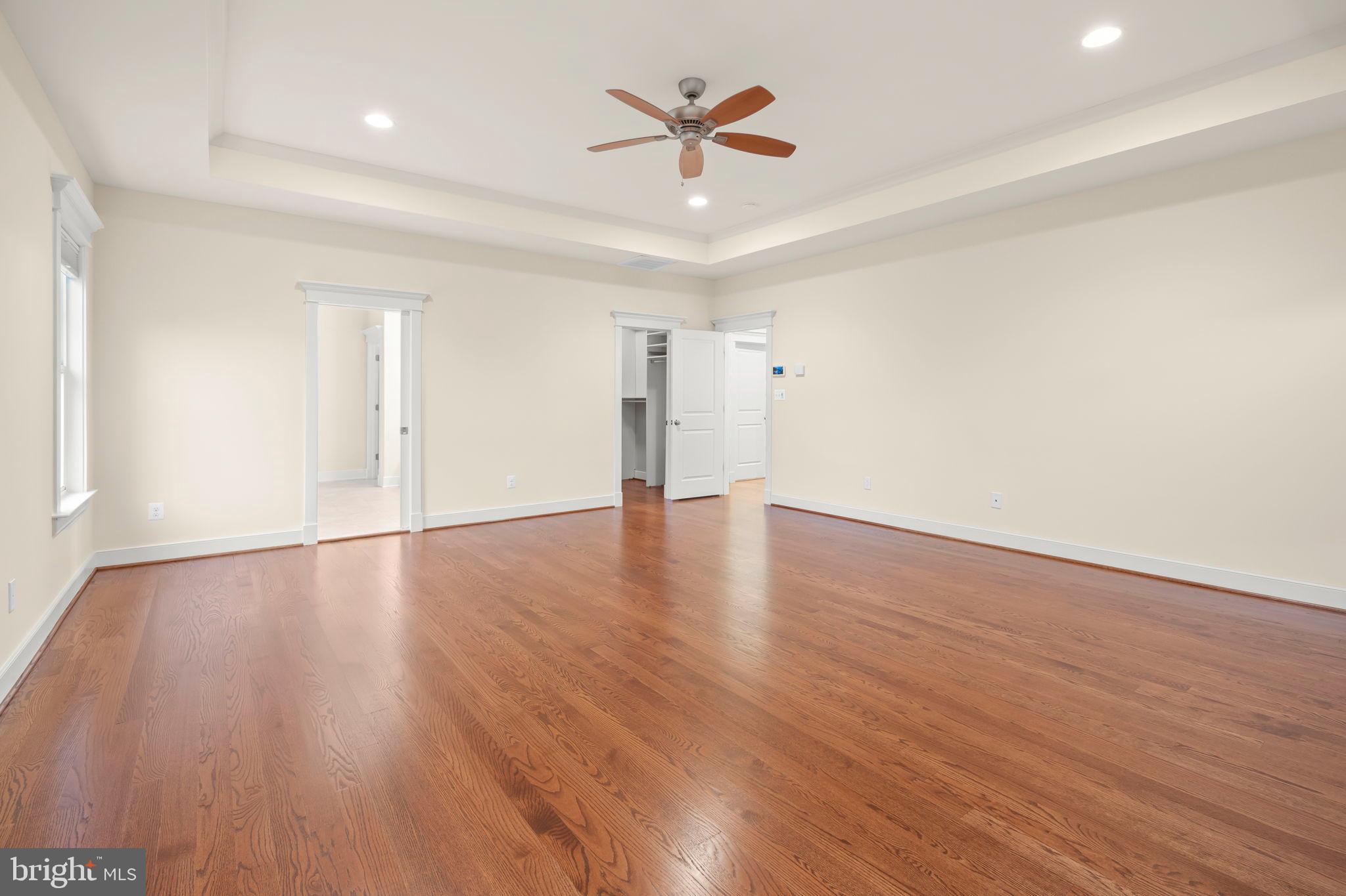 217 Pleasant Street Southwest Vienna, VA 22180 - Photo 52 of 80 an empty room with wooden floor and ceiling fan