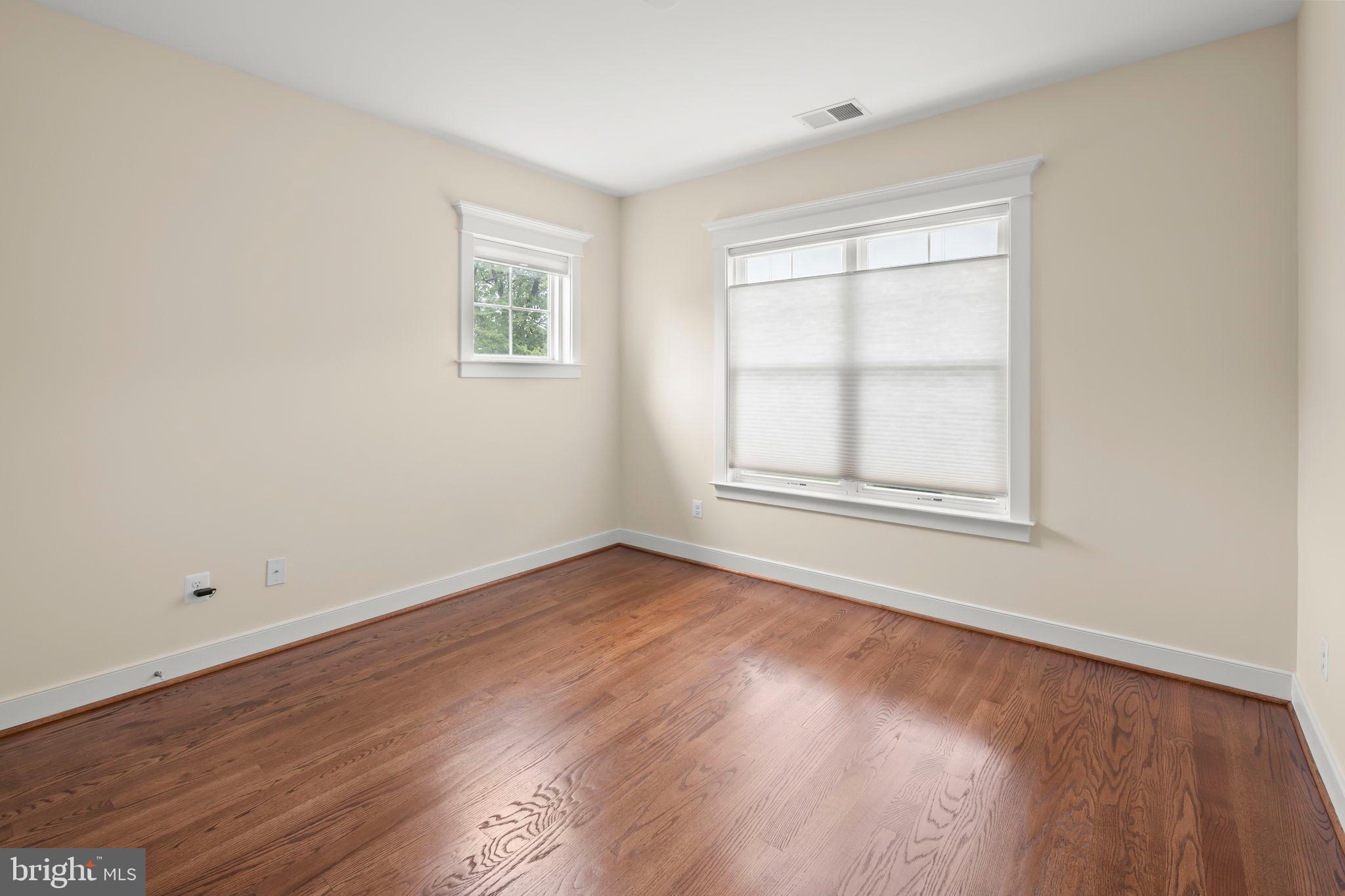217 Pleasant Street Southwest Vienna, VA 22180 - Photo 59 of 80 an empty room with wooden floor and windows