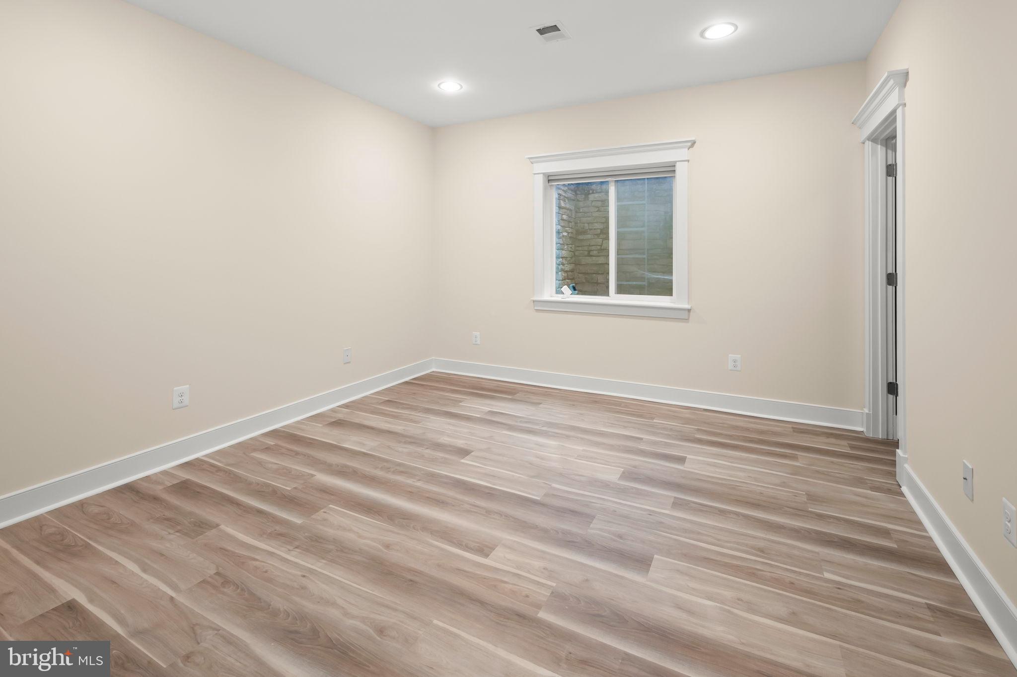 217 Pleasant Street Southwest Vienna, VA 22180 - Photo 74 of 80 an empty room with wooden floor and windows