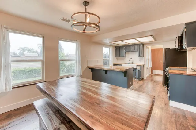 a large kitchen with stainless steel appliances granite countertop a stove and refrigerator