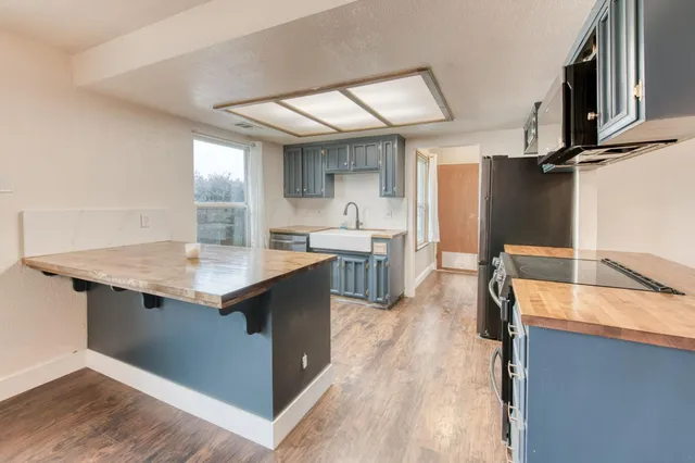 a kitchen with stainless steel appliances granite countertop a sink counter space and cabinets