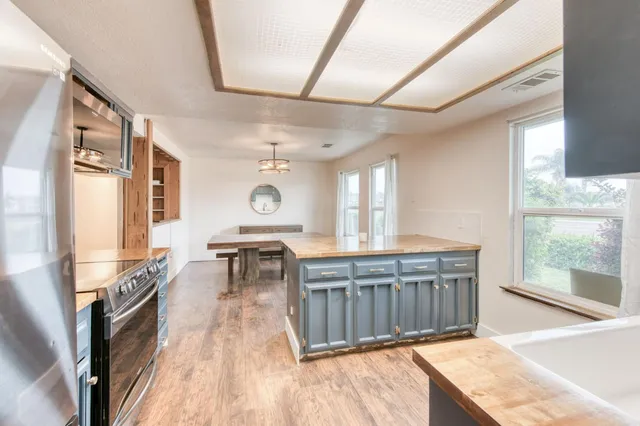 a view of a kitchen with sink and windows