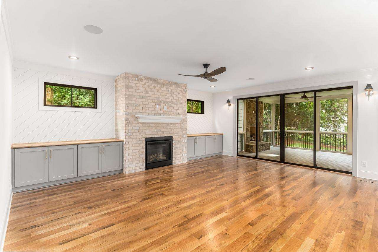 Grand Living Room w/ Built-in Cabinets, Masonry Fireplace + Shiplap accent walls. Screened Porch doors are Double Slider Living Room