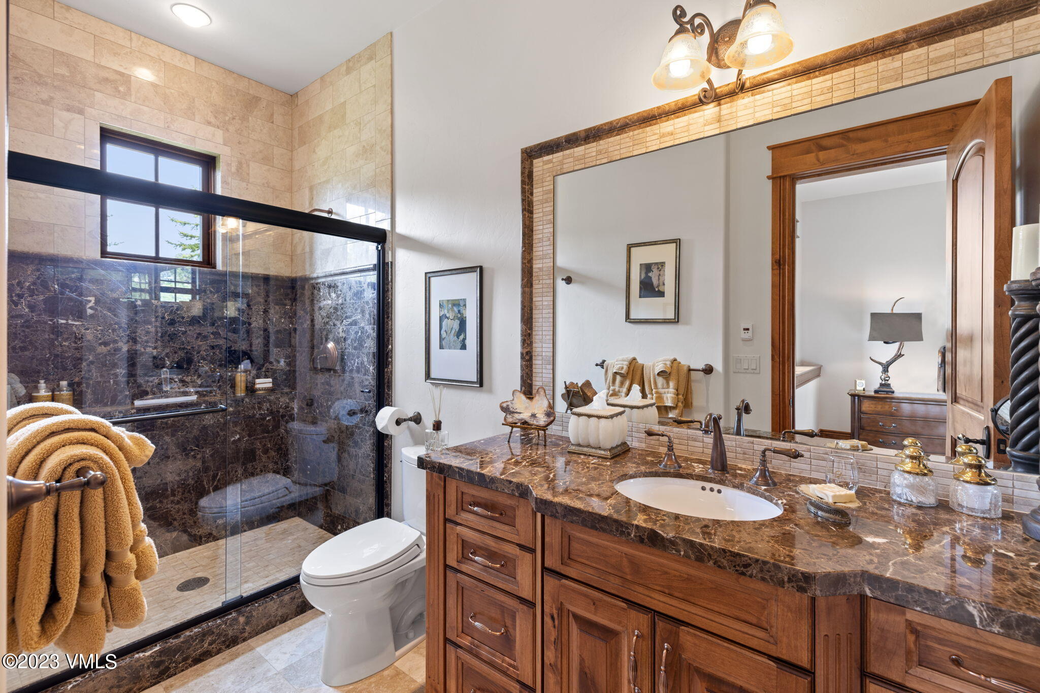 940 Summit Trail Edwards, CO 81632 - Photo 41 of 64 a bathroom with a granite countertop sink mirror vanity and toilet