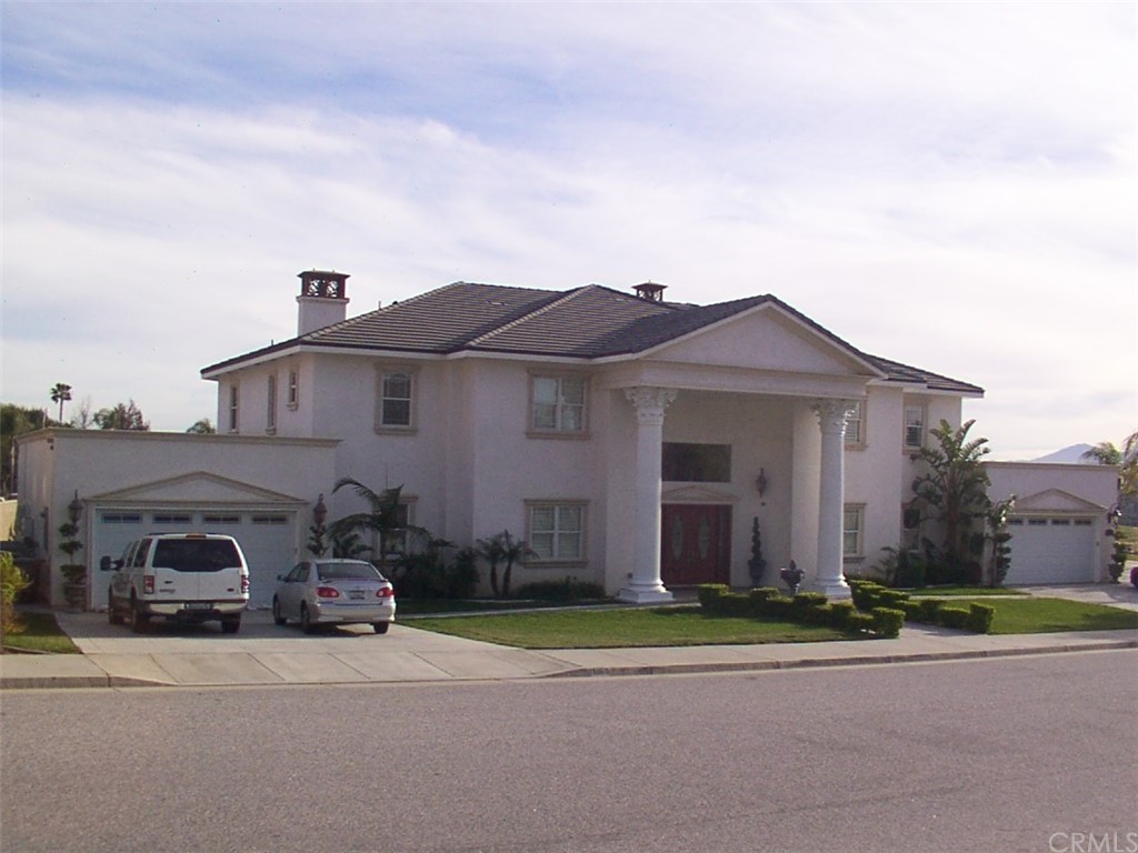 641 Taca Court Riverside, CA 92507 - Photo 1 of 1 a front view of a house with a garden and parking space