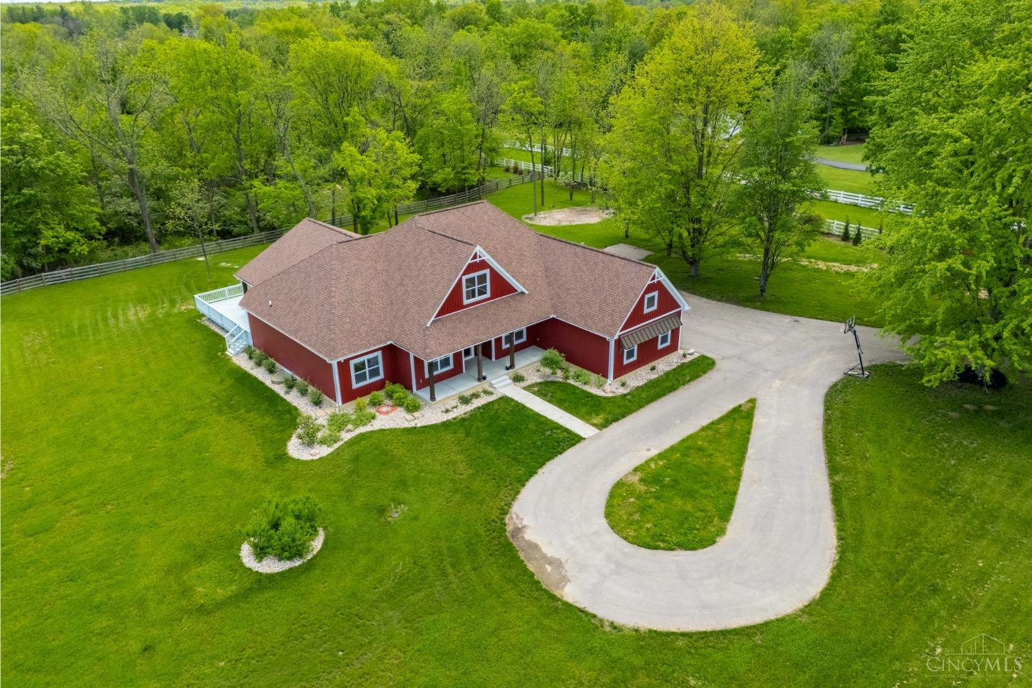 761 Barg Salt Run Road Cincinnati, OH 45245 - Photo 1 of 67 Welcome to your dream home—custom built just two years ago and set on nearly six serene acres, with approximately four acres already fenced in. This stunning property offers over 5,000 square feet of living space, featuring four spacious bedrooms on the main floor, including a luxurious owner's suite with a spa-inspired custom shower. The open-concept kitchen includes built-in appliances and flows beautifully into the bright and airy living areas. The finished lower level provides a massive recreational space ready for your personal touch, with an egress window already in place. Thoughtfully designed with comfort and convenience in mind, the home also features a custom dog shower off the laundry room, a three-car garage, and an expansive deck complete with an outdoor kitchen and a hot tub for relaxing under the stars. Perfectly situated off the beaten path yet close to everything, this home offers the best of private country living with modern luxury.