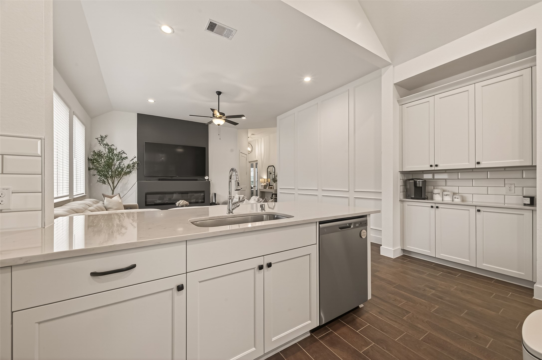 5019 Country Mdws Trail Rosharon, TX 77583 - Photo 13 of 49 a kitchen with a sink dishwasher and white cabinets with wooden floor