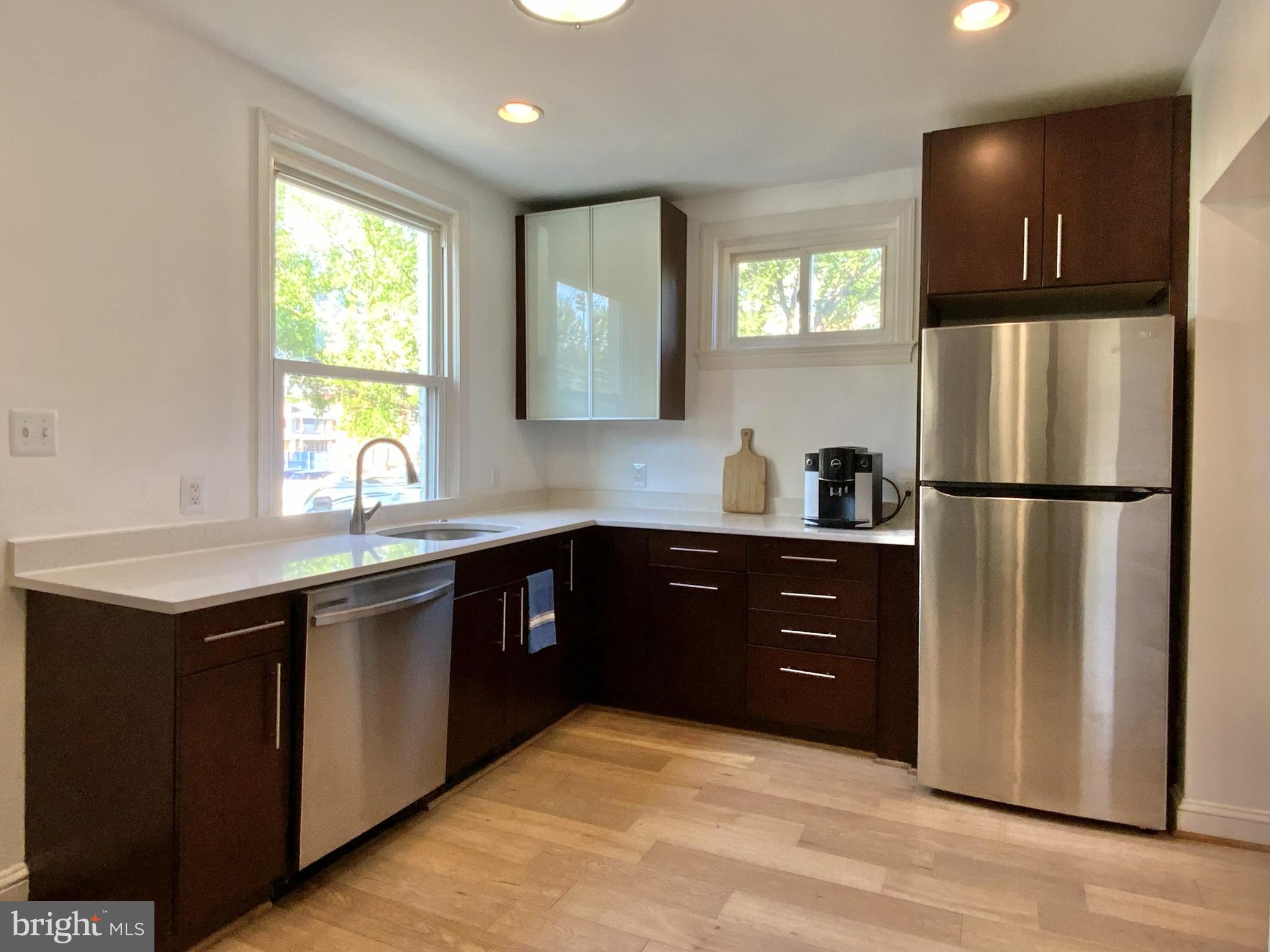 1772 E Street Northeast Washington, DC 20002 - Photo 9 of 23 a kitchen with a refrigerator and a sink