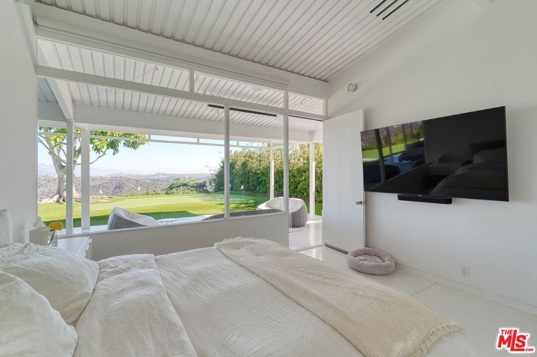 2262 Stradella Road Los Angeles, CA 90077 - Photo 21 of 26 a view of a living room and a floor to ceiling window