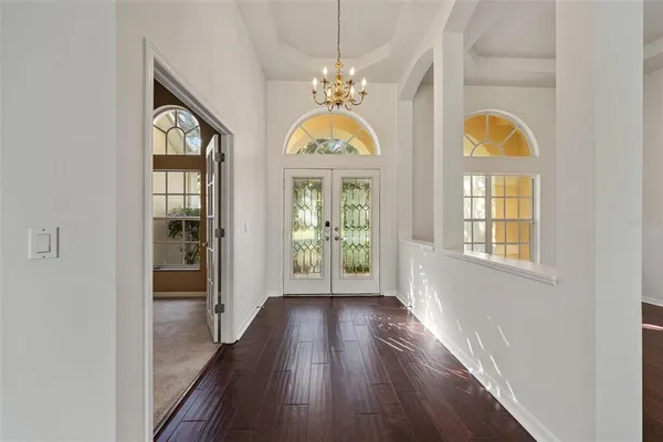 a view of front door with wooden floor and window