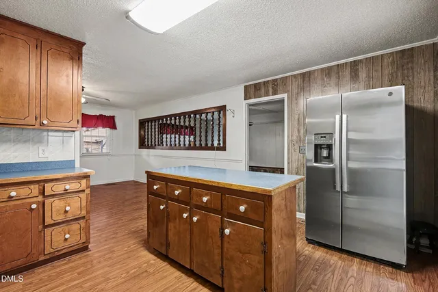 a kitchen with stainless steel appliances granite countertop a refrigerator and a stove