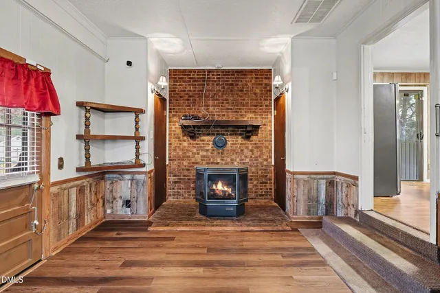 a view of a livingroom with a fireplace and furniture