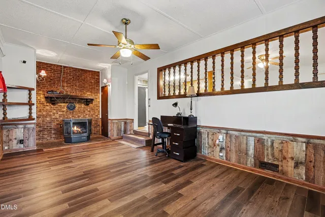 a view of livingroom with furniture fireplace and wooden floor