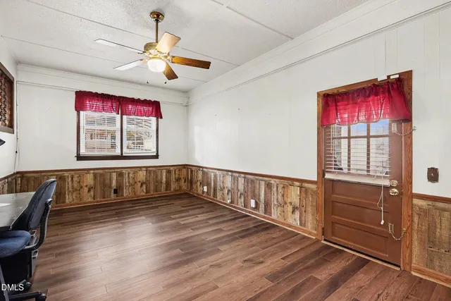 a view of empty room with wooden floor