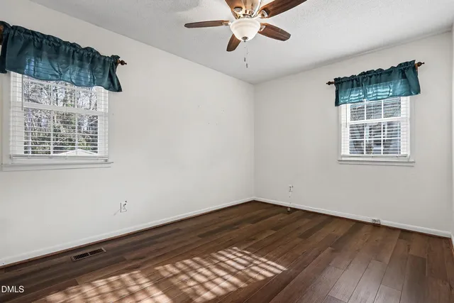 an empty room with a ceiling fan