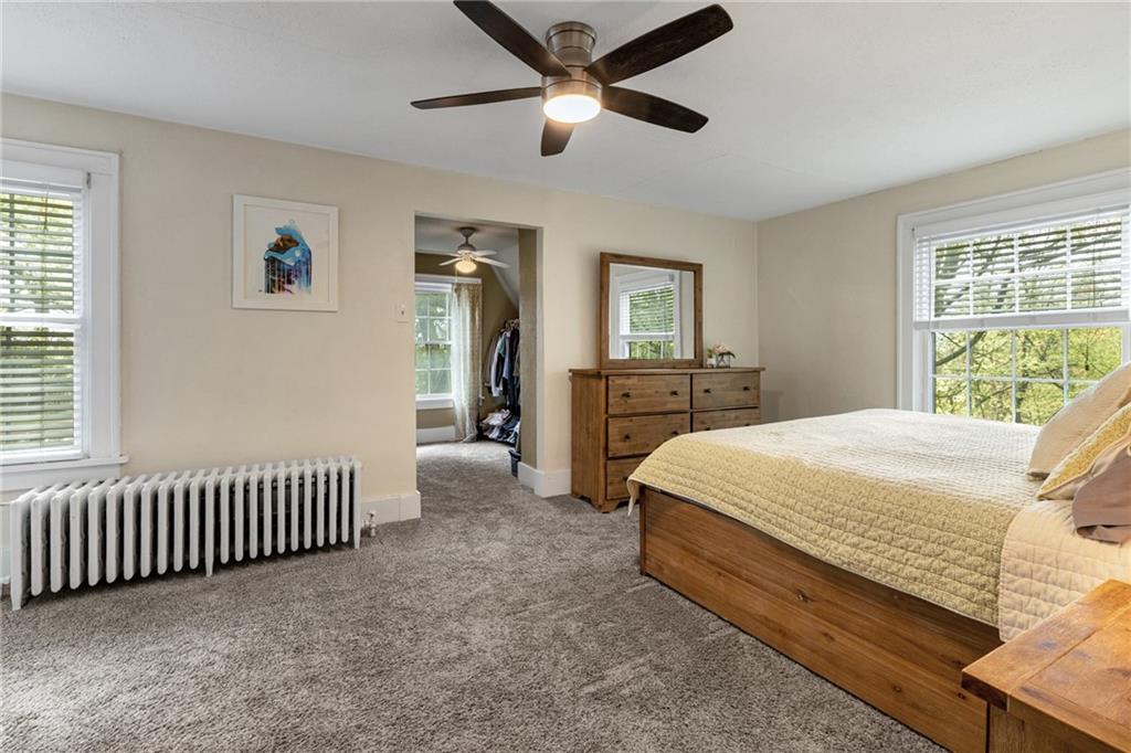 305 7th Street Beaver Falls, PA 15010 - Photo 29 of 37 a spacious bedroom with a bed and a chandelier