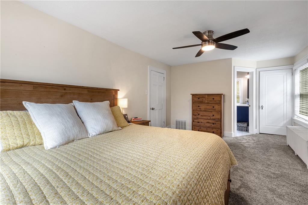 305 7th Street Beaver Falls, PA 15010 - Photo 30 of 37 a bedroom with a large bed and a chandelier
