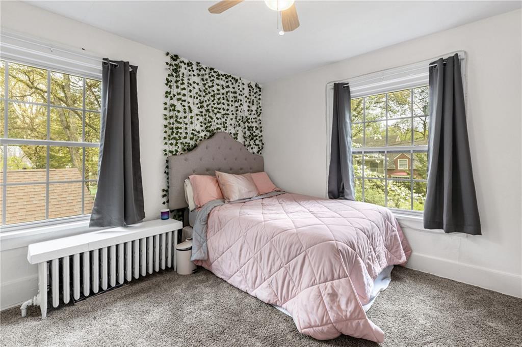 305 7th Street Beaver Falls, PA 15010 - Photo 35 of 37 a bed sitting in a bedroom next to a window