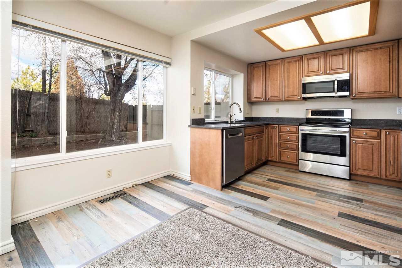 3175 Alpine Creek Road Reno, NV 89519 - Photo 3 of 25 a kitchen with stainless steel appliances granite countertop a stove microwave and sink