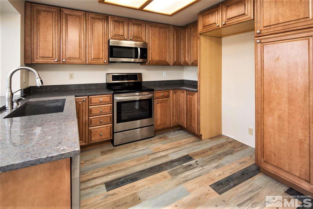 3175 Alpine Creek Road Reno, NV 89519 - Photo 4 of 25 a kitchen with stainless steel appliances granite countertop a stove a sink and a microwave