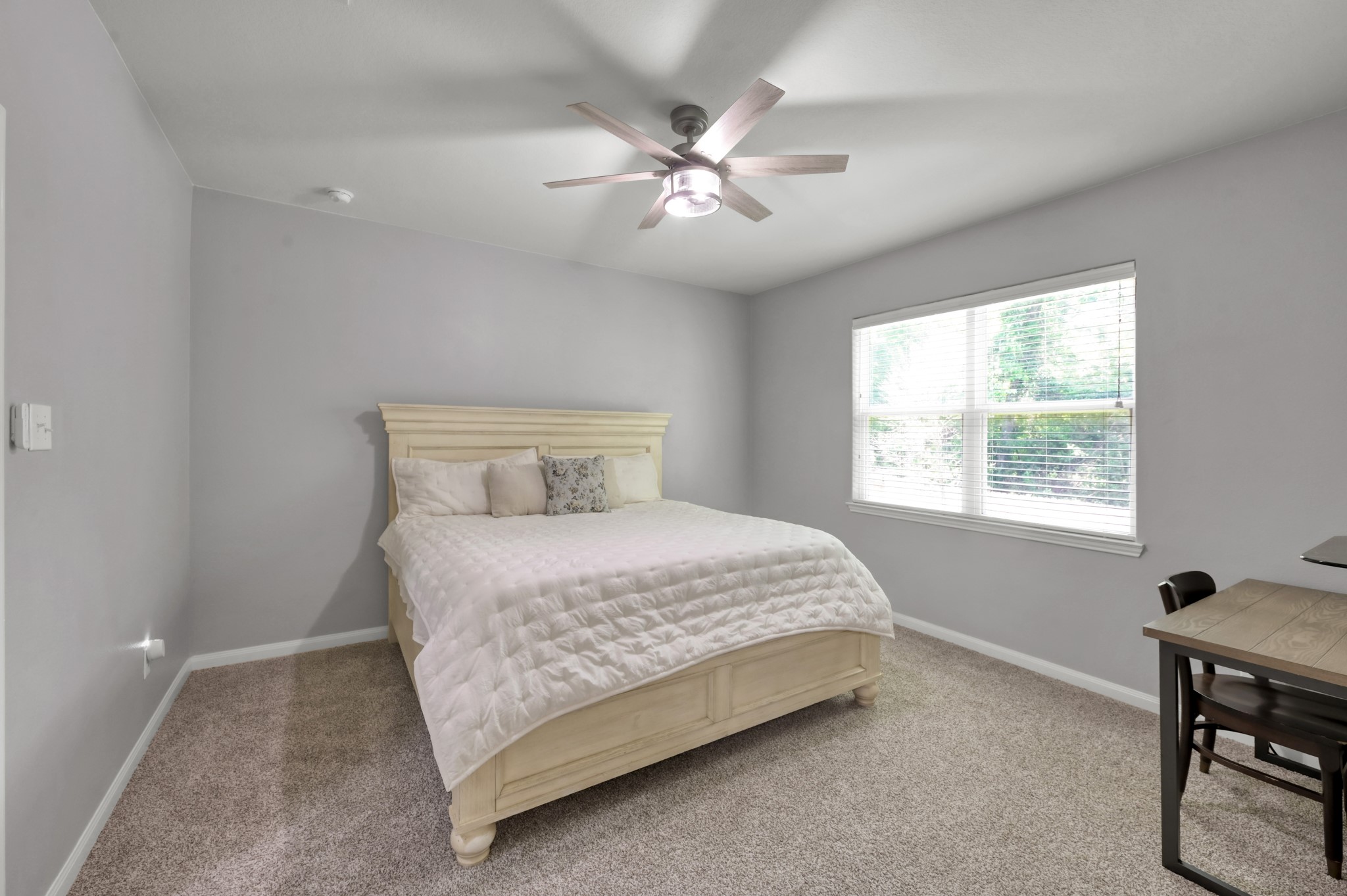 7562 Fettle Lane Conroe, TX 77304 - Photo 17 of 30 Spacious primary bedroom featuring peaceful nature views, abundant natural light, and no rear neighbors for added privacy.