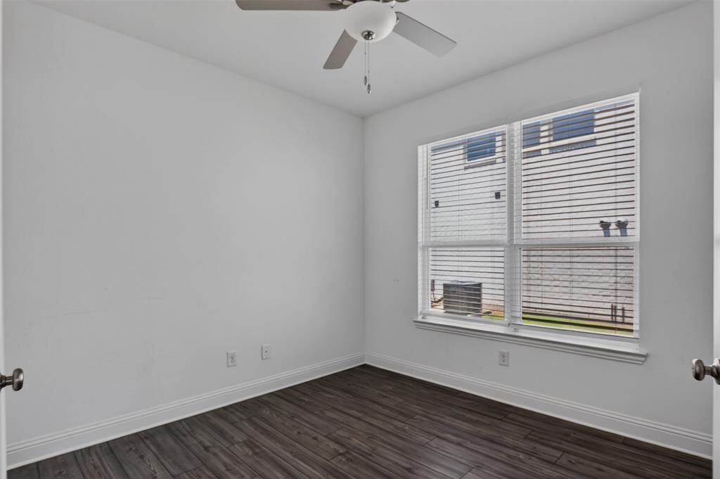 845 Ranchland Road Justin, TX 76247 - Photo 11 of 22 a view of an empty room with wooden floor and a window