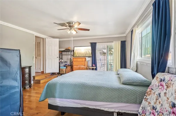 a bedroom with a large bed and a chandelier