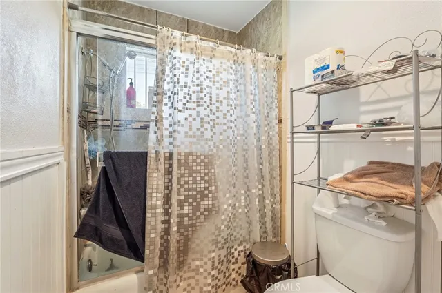 a bedroom with a bed wooden floor and window