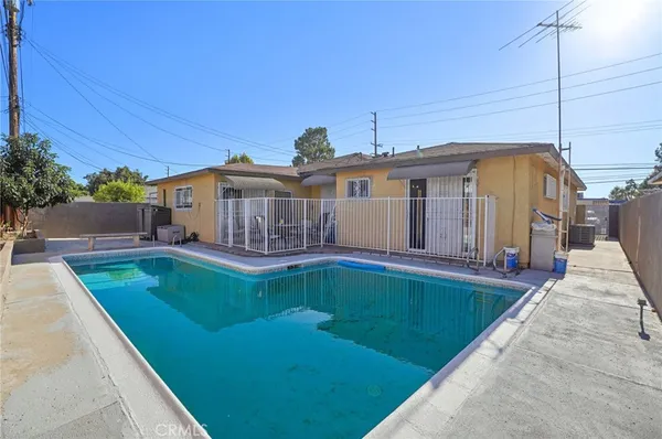 a view of a backyard with wooden fence