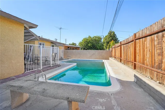 a view of a chairs and table in patio with wooden fence