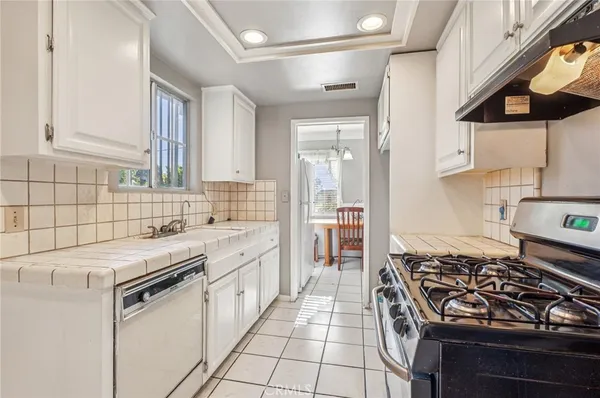 a kitchen that has a sink and a stove