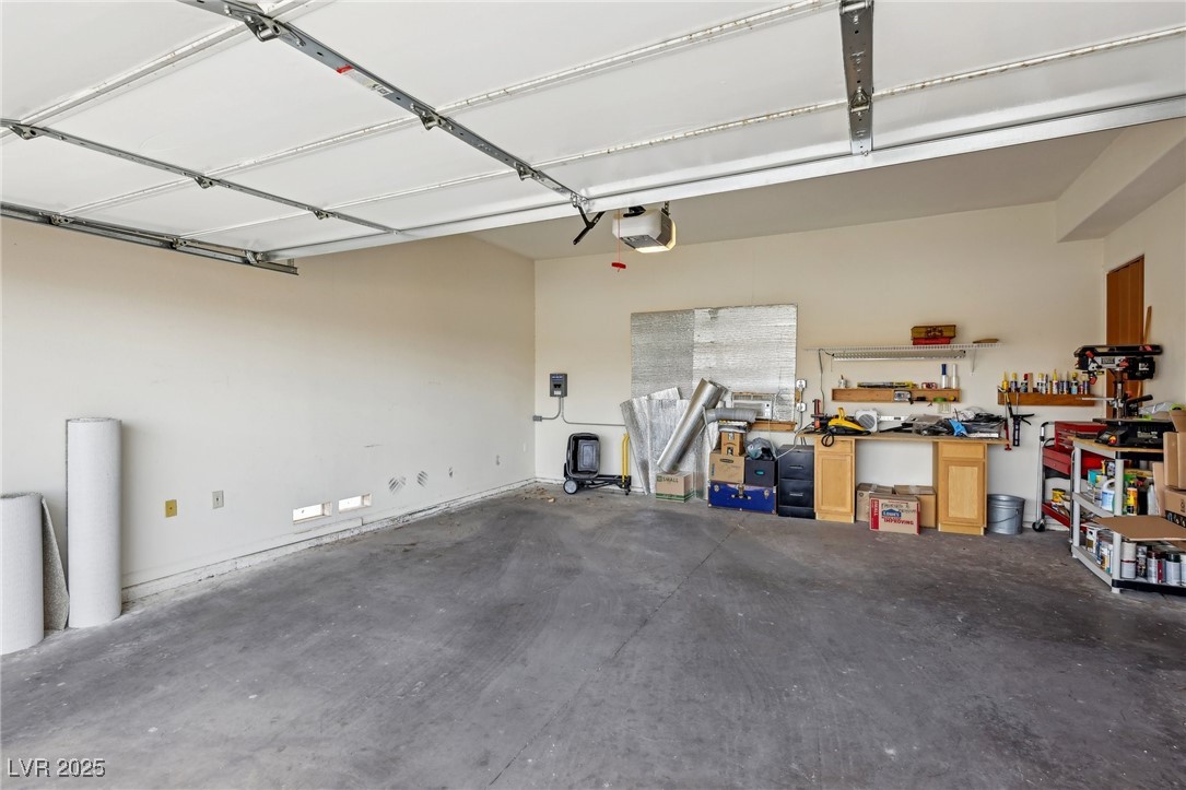 519 North Racetrack Road Henderson, NV 89015 - Photo 68 of 98 Garage with a workshop area and a garage door opener
