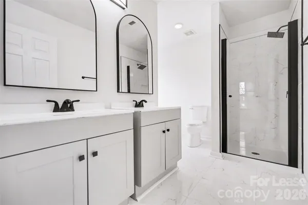 a bathroom with a double vanity sink mirror and
