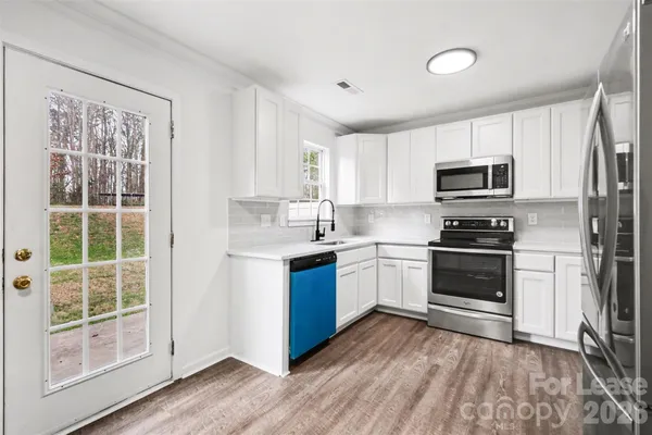 a kitchen with a refrigerator stove and microwave