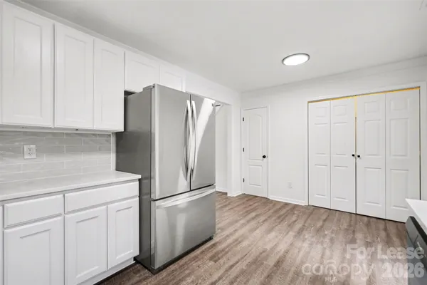 a kitchen with a refrigerator sink and cabinets