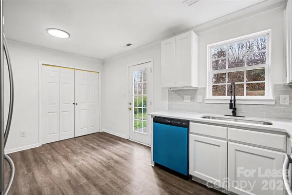 a kitchen with a sink stove and cabinets