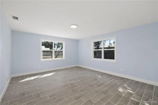 a view of empty room with windows