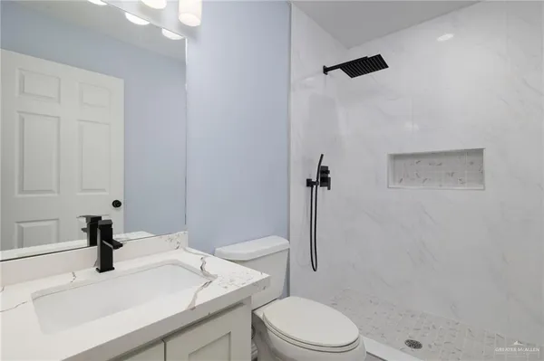 a bathroom with a sink toilet and shower