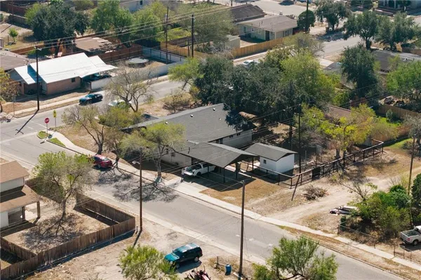 an aerial view of a house with a yard and lake