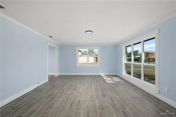 wooden floor in an empty room with a window