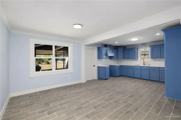 a view of kitchen with wooden floor and window