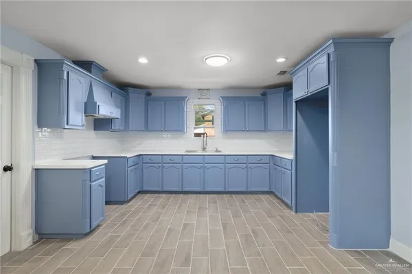 a kitchen with stainless steel appliances granite countertop a large stove a sink dishwasher and a refrigerator with wooden cabinets